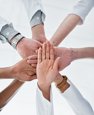 Buy stock photo Closeup shot of a group of medical practitioners joining their hands together in a huddle