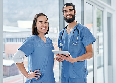 Buy stock photo Portrait of two medical practitioners using a digital tablet together in a hospital