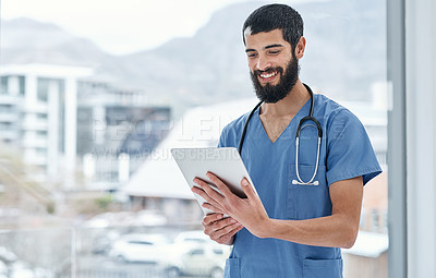 Buy stock photo Shot of a medical practitioner using a digital tablet in a hospital
