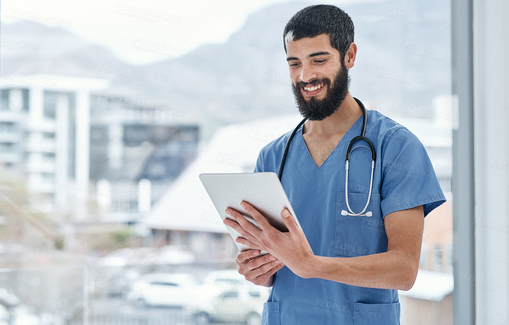 Buy stock photo Shot of a medical practitioner using a digital tablet in a hospital