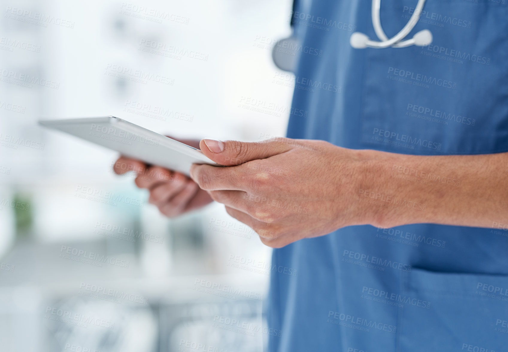 Buy stock photo Closeup shot of a medical practitioner using a digital tablet in a hospital