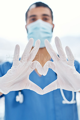 Buy stock photo Closeup shot of a medical practitioner making a heart shape with his hands