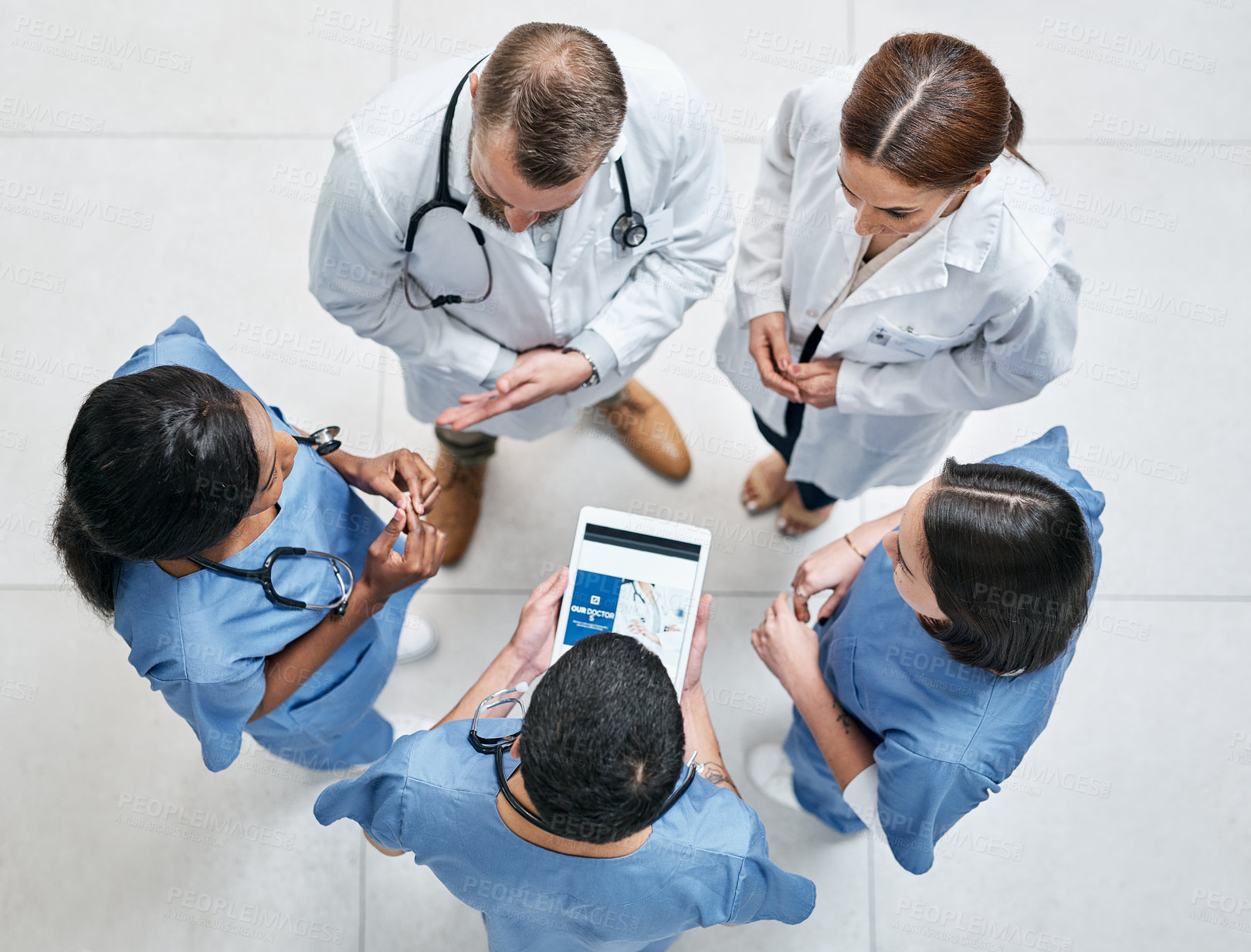 Buy stock photo High angle shot of a group of medical practitioners having a discussion in a hospital