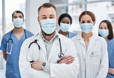 Buy stock photo Portrait of a group of medical practitioners wearing face masks in a hospital