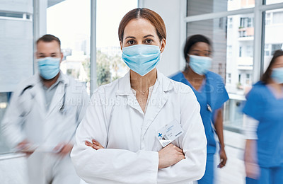 Buy stock photo Portrait of a doctor wearing a face mask in a busy hospital
