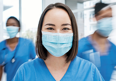 Buy stock photo Portrait of a doctor wearing a face mask in a busy hospital