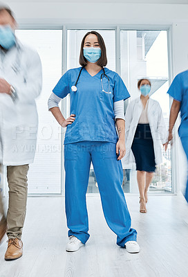 Buy stock photo Portrait of a doctor wearing a face mask in a busy hospital