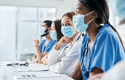Buy stock photo Portrait of a doctor sitting alongside her colleagues during a meeting in a hospital boardroom