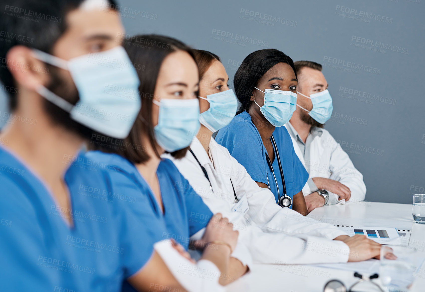 Buy stock photo Portrait of a doctor sitting alongside her colleagues during a meeting in a hospital boardroom