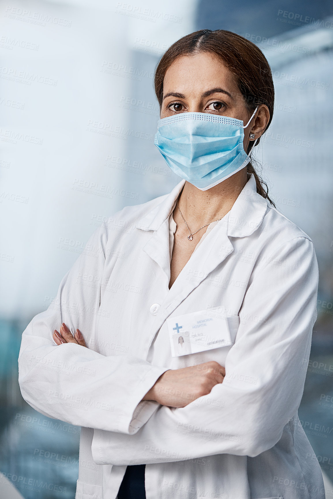 Buy stock photo Portrait of a medical practitioner wearing a face mask in a hospital