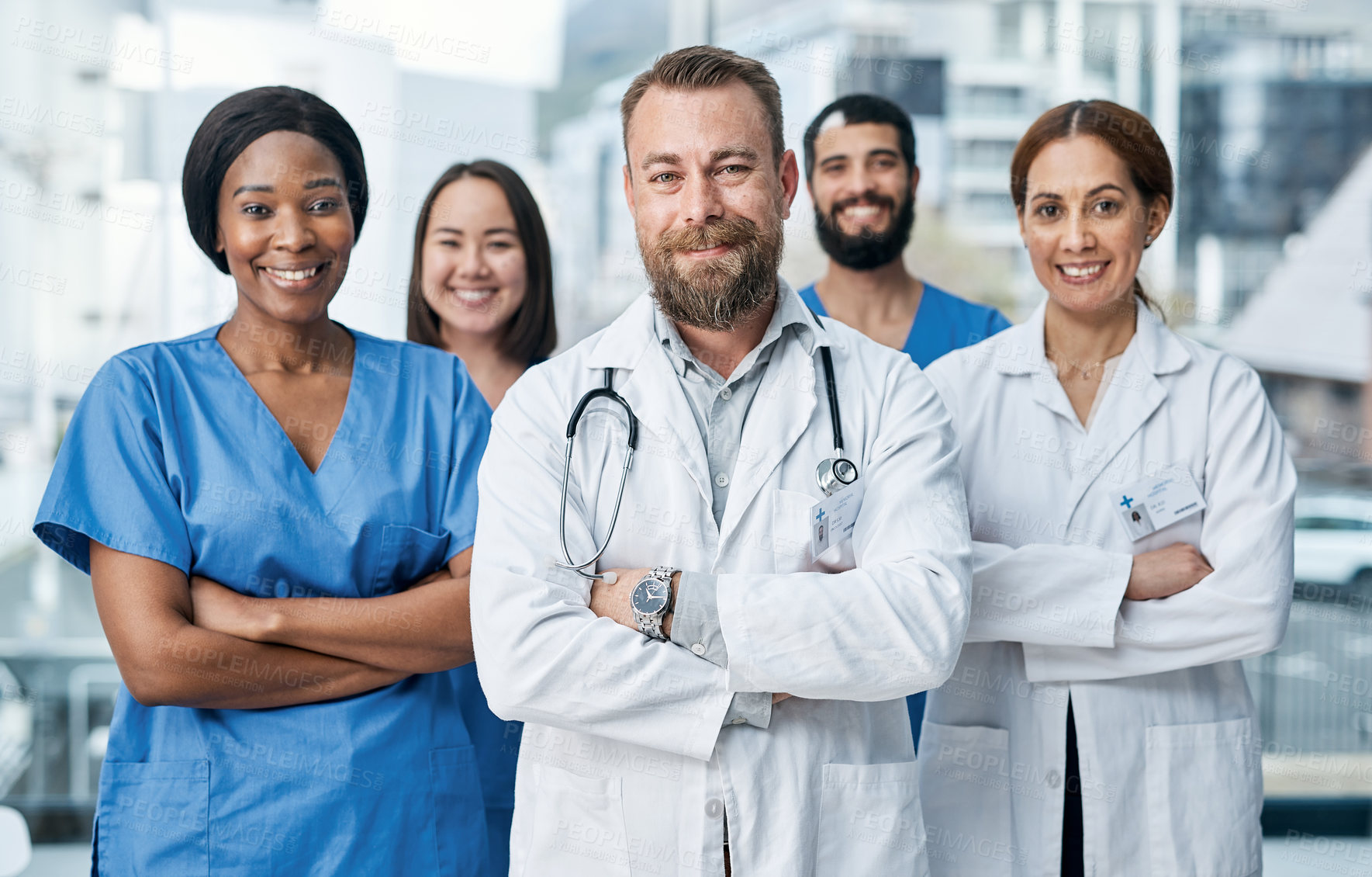 Buy stock photo Portrait of a group of medical practitioners standing together in a hospital