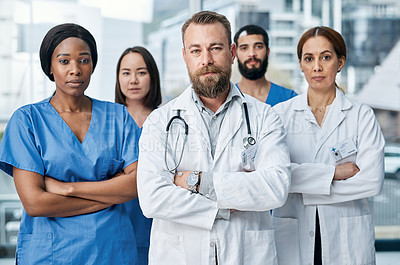 Buy stock photo Portrait of a group of medical practitioners standing together in a hospital