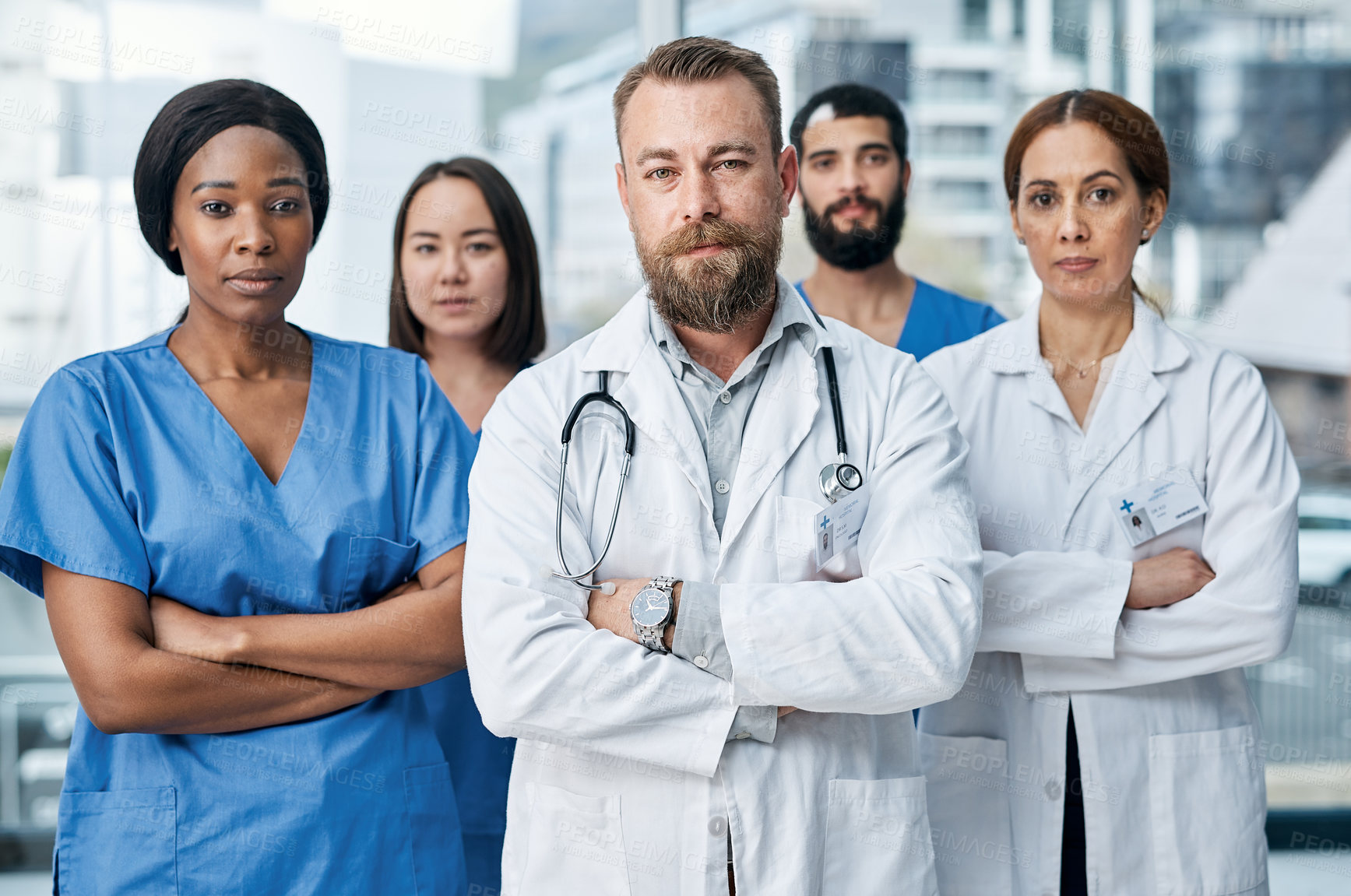 Buy stock photo Portrait of a group of medical practitioners standing together in a hospital