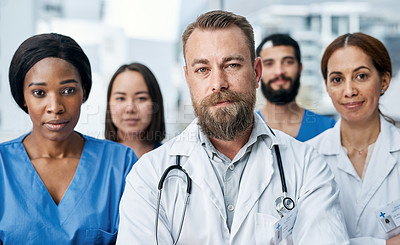 Buy stock photo Portrait of a group of medical practitioners standing together in a hospital