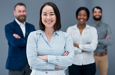 Buy stock photo Portrait of a group of businesspeople standing together against a grey background