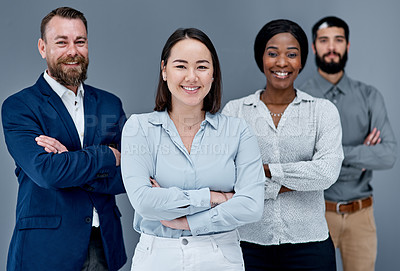 Buy stock photo Portrait of a group of businesspeople standing together against a grey background