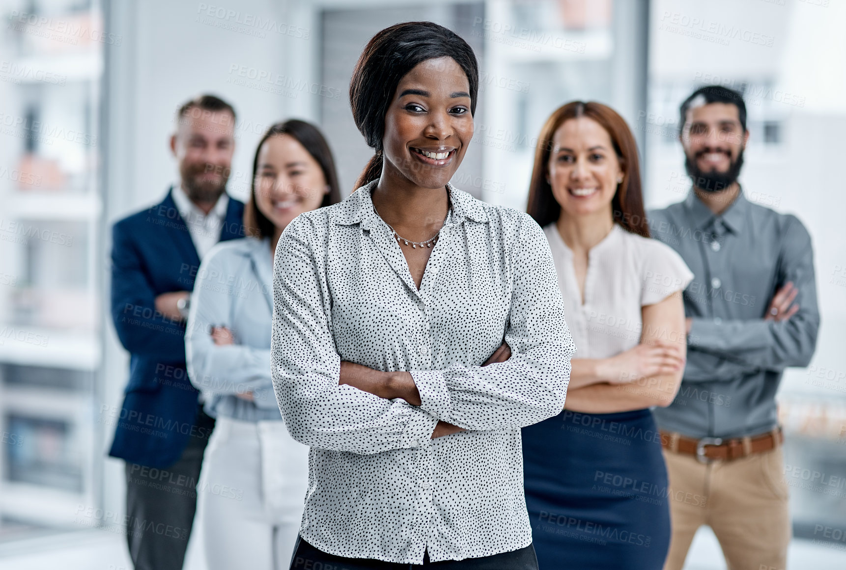 Buy stock photo Portrait of a businesswoman standing in an office with her colleagues in the background