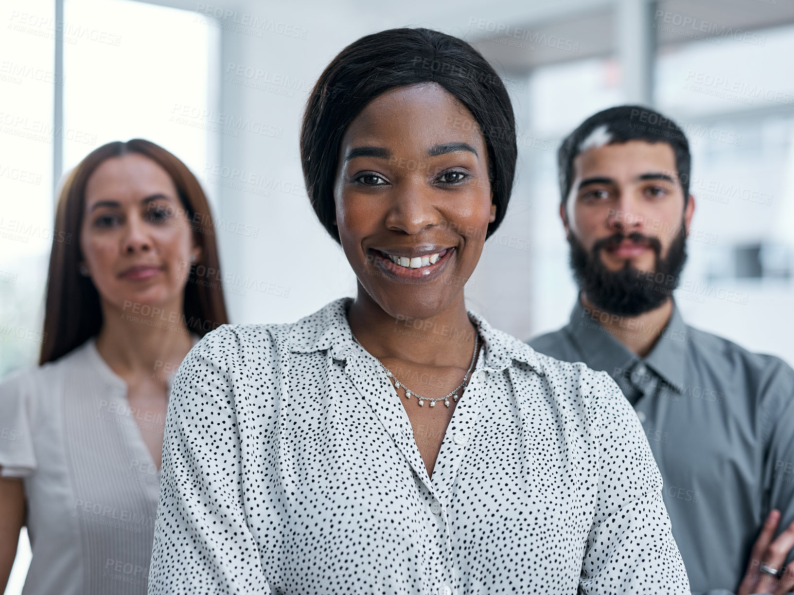 Buy stock photo Portrait of a businesswoman standing in an office with her colleagues in the background