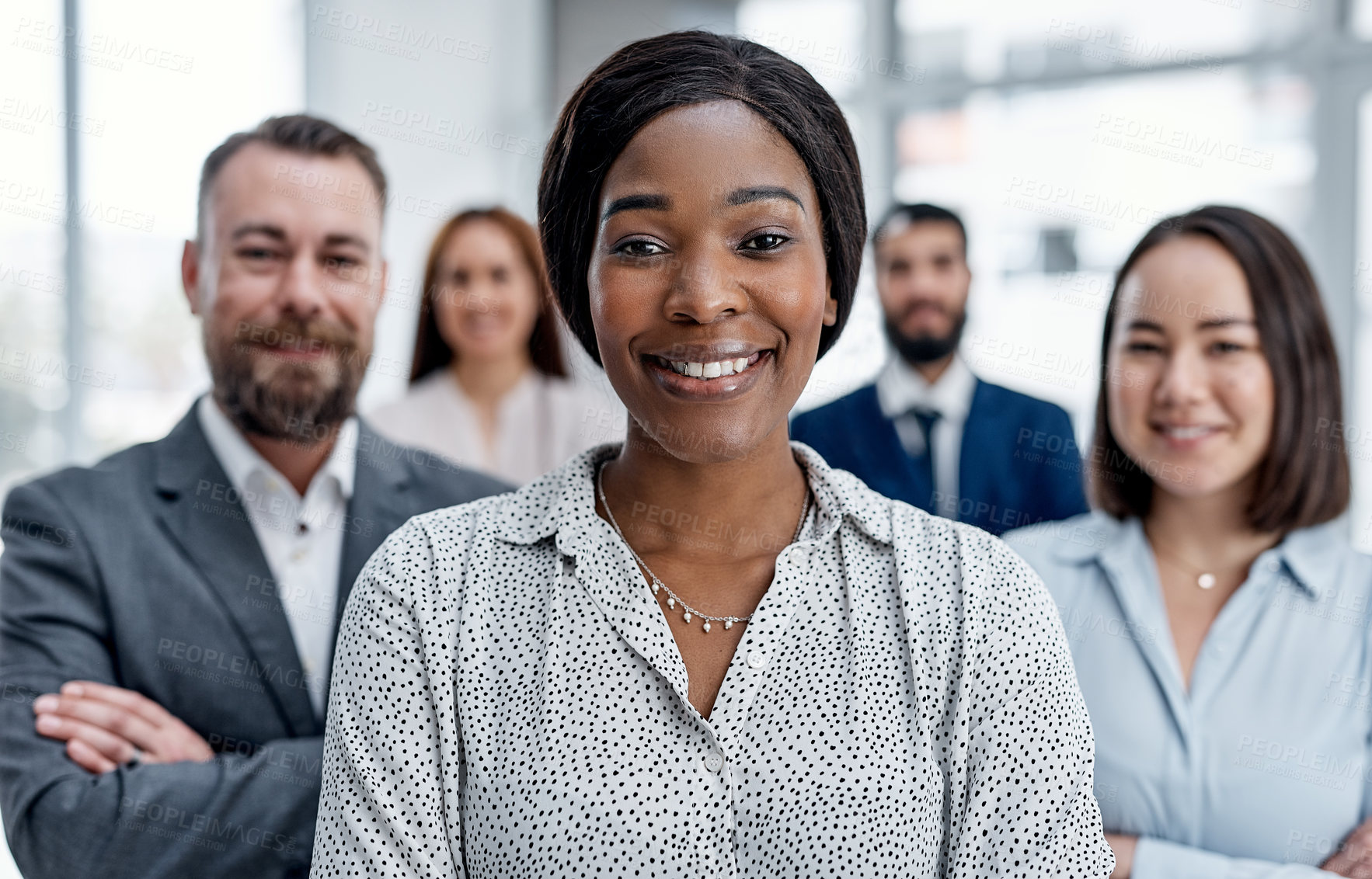 Buy stock photo Portrait of a businesswoman standing in an office with her colleagues in the background