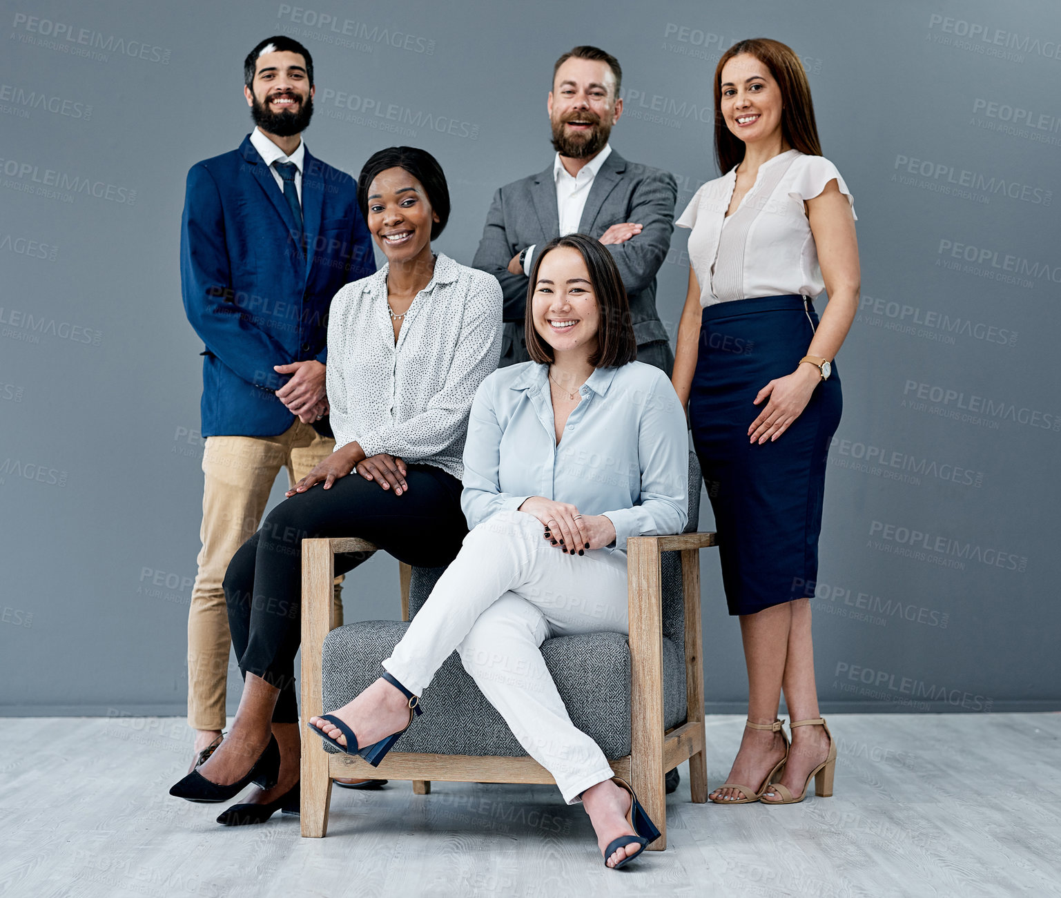 Buy stock photo Portrait of a group of businesspeople posing together against a grey background