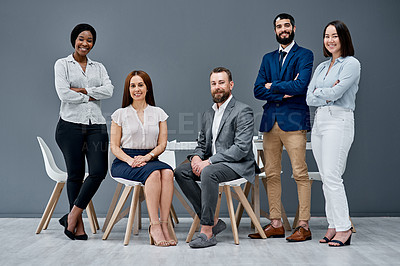 Buy stock photo Portrait of a group of businesspeople posing together against a grey background
