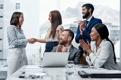 Buy stock photo Shot of a group of businesspeople applauding their colleagues in an office