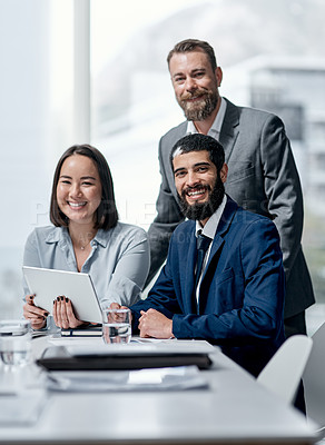 Buy stock photo Portrait of a group of businesspeople working together on a digital tablet in an office