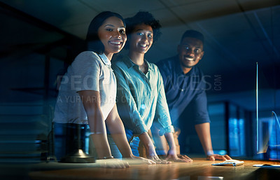 Buy stock photo Portrait of a group of young businesspeople using a computer together during a late night at work