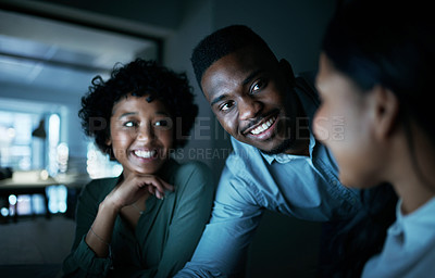 Buy stock photo Shot of a group of young businesspeople using a computer together during a late night at work