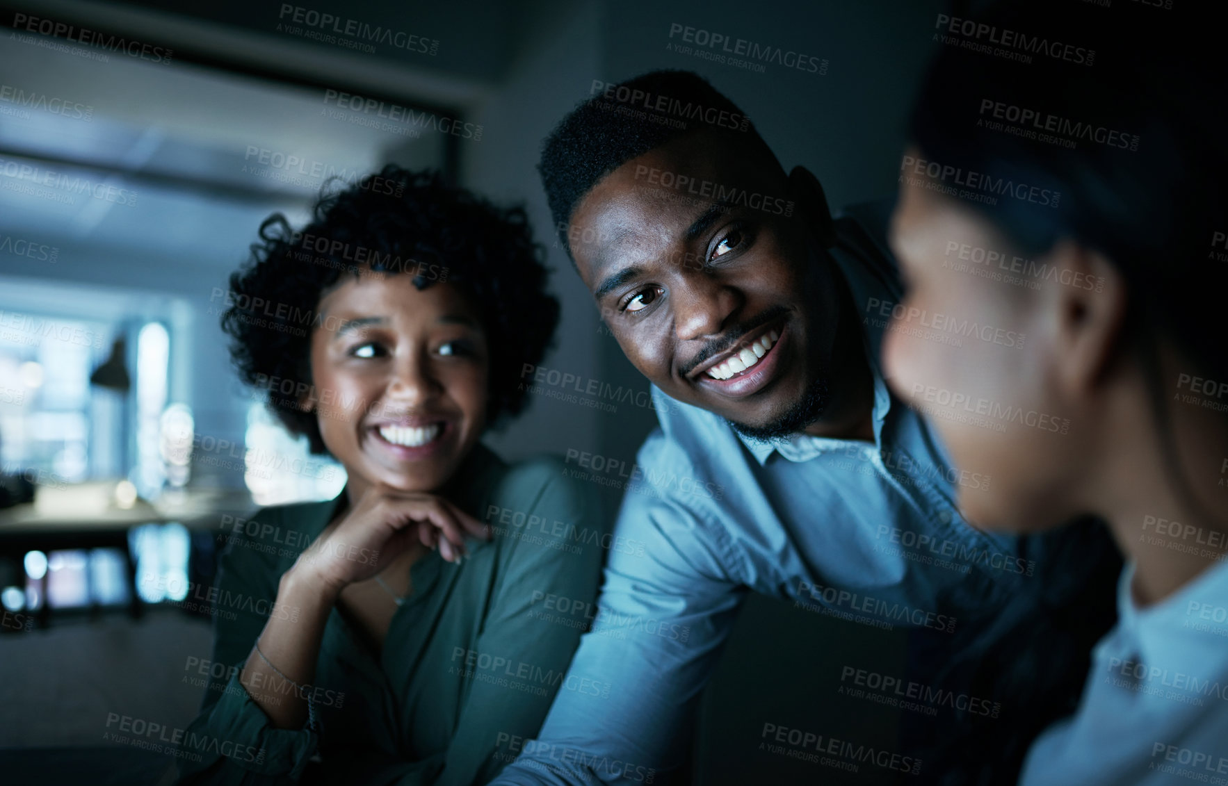 Buy stock photo Shot of a group of young businesspeople using a computer together during a late night at work