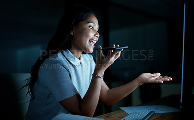 Buy stock photo Shot of a young businesswoman using a smartphone and computer during a late night at work