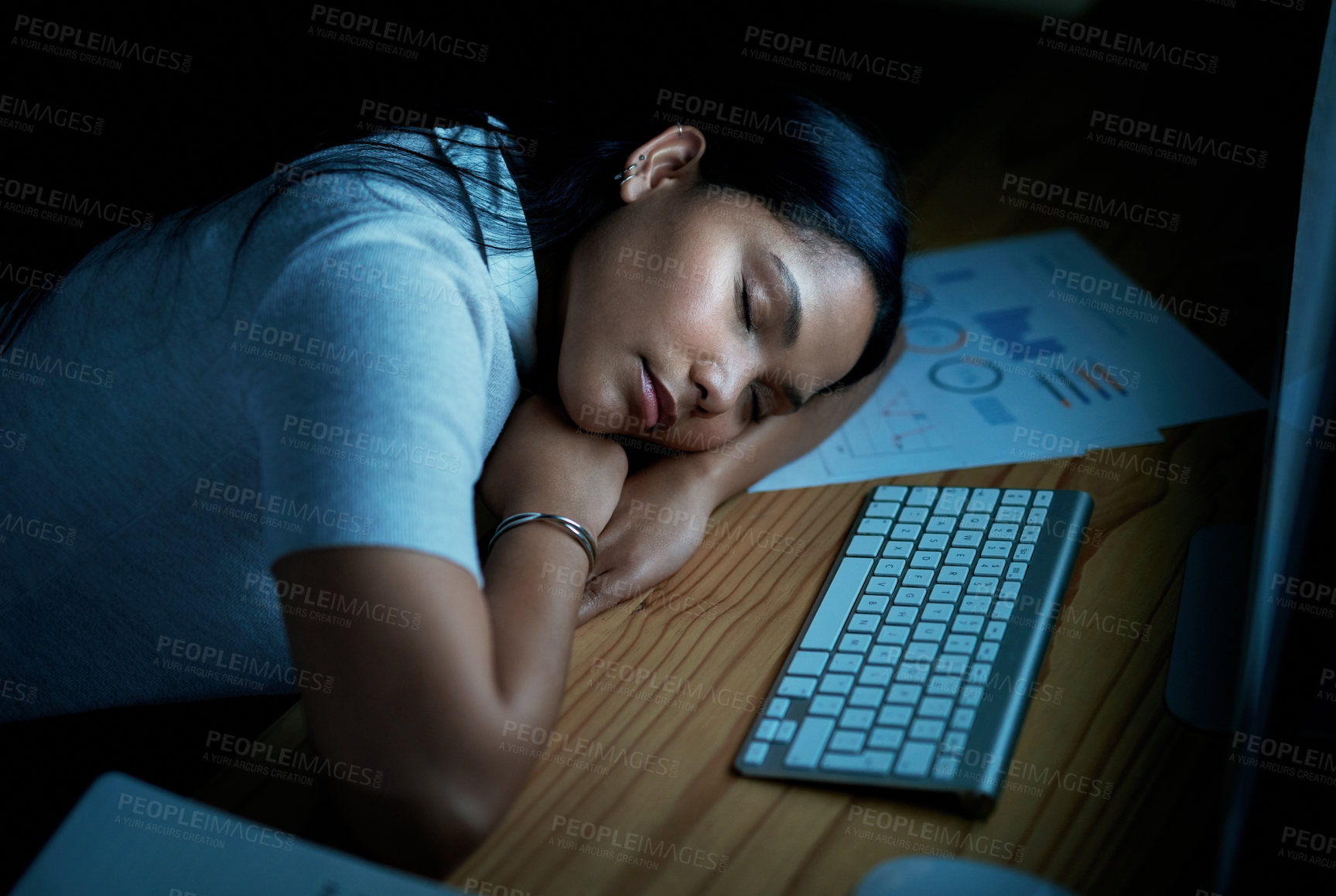 Buy stock photo Shot of young businesswoman sleeping at her desk during a late night in a modern office