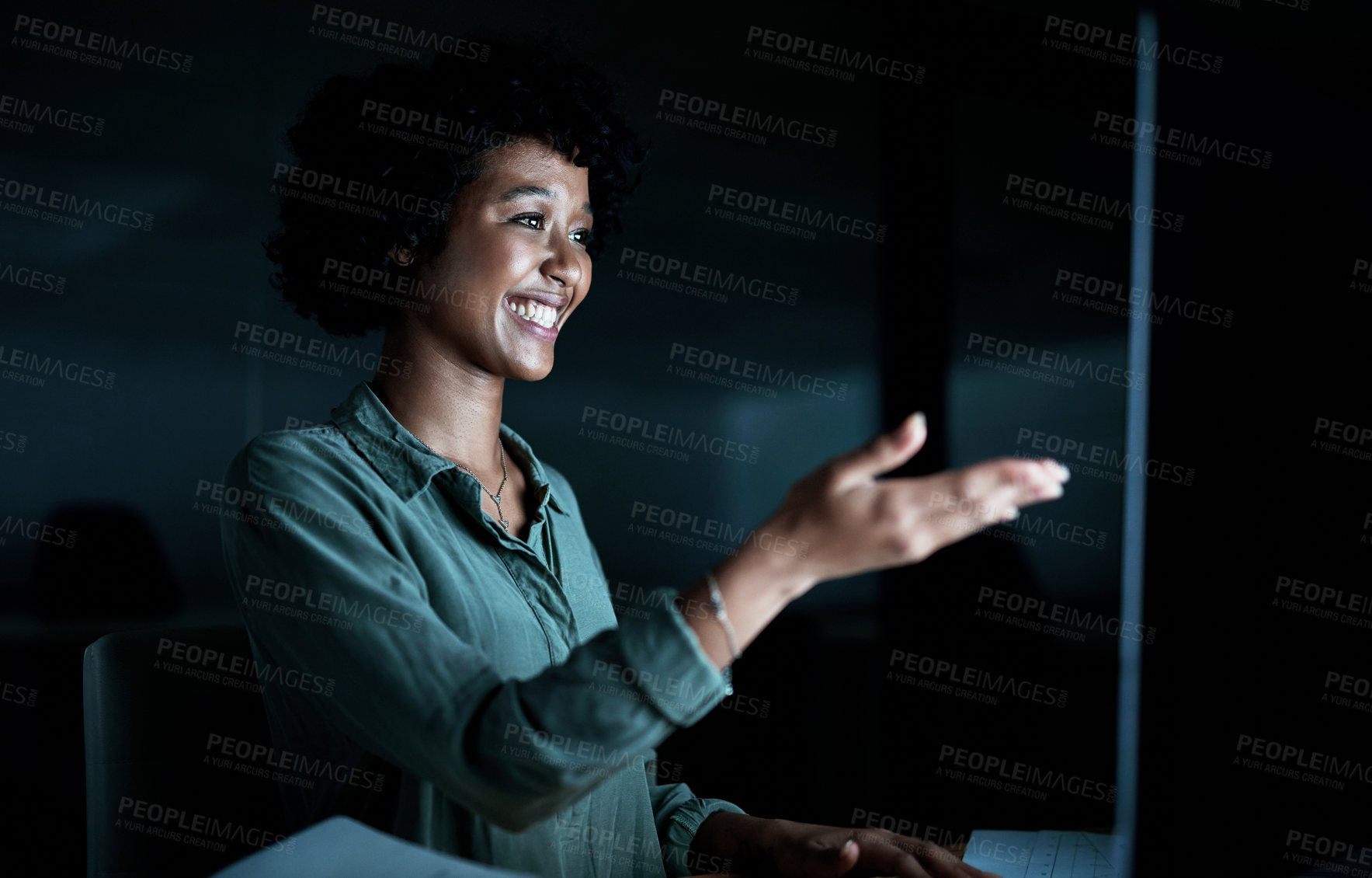 Buy stock photo Shot of a young businesswoman using a computer to make a video call during a late night at work