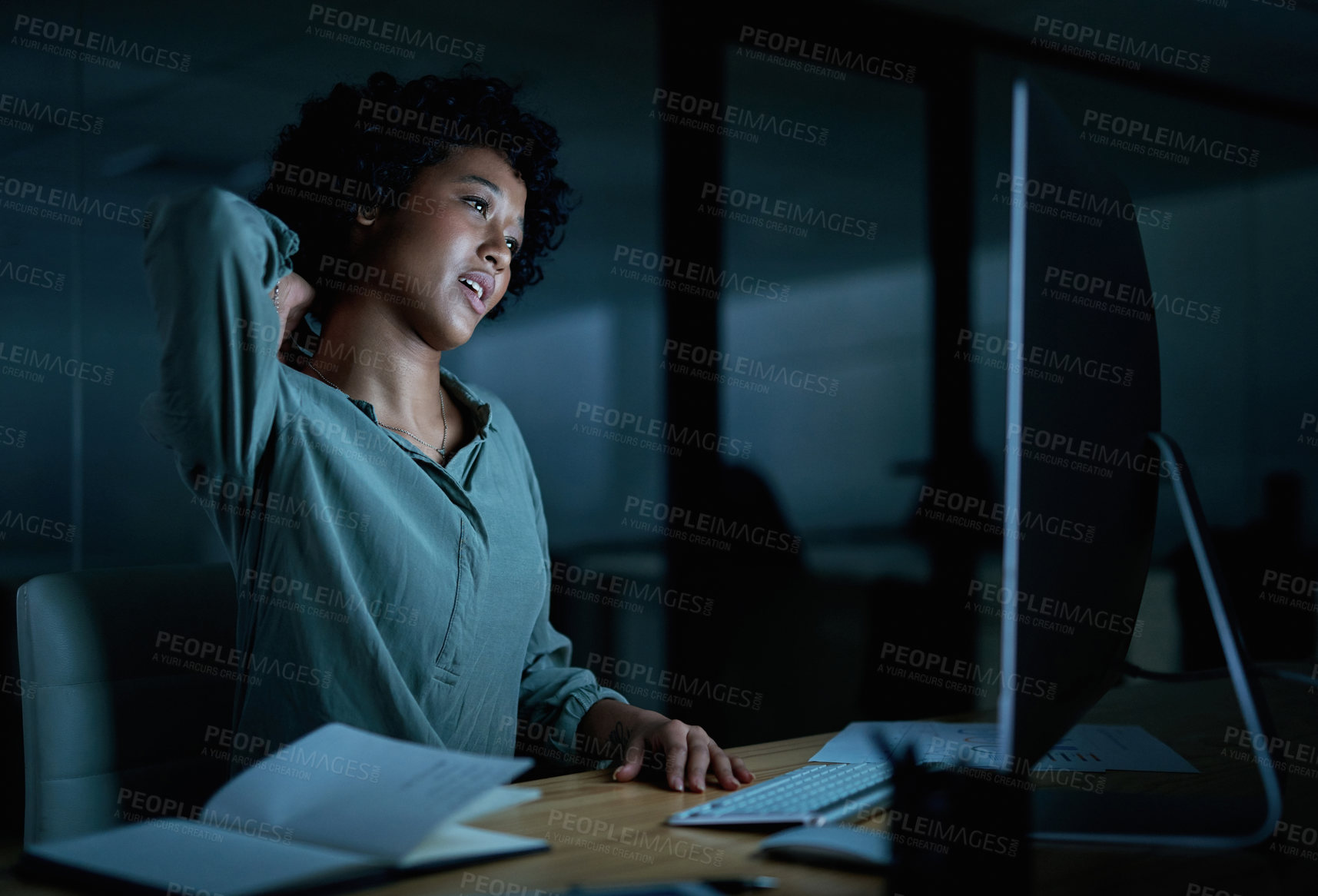 Buy stock photo Shot of a young businesswoman experiencing neck pain while using a computer during a late night at work