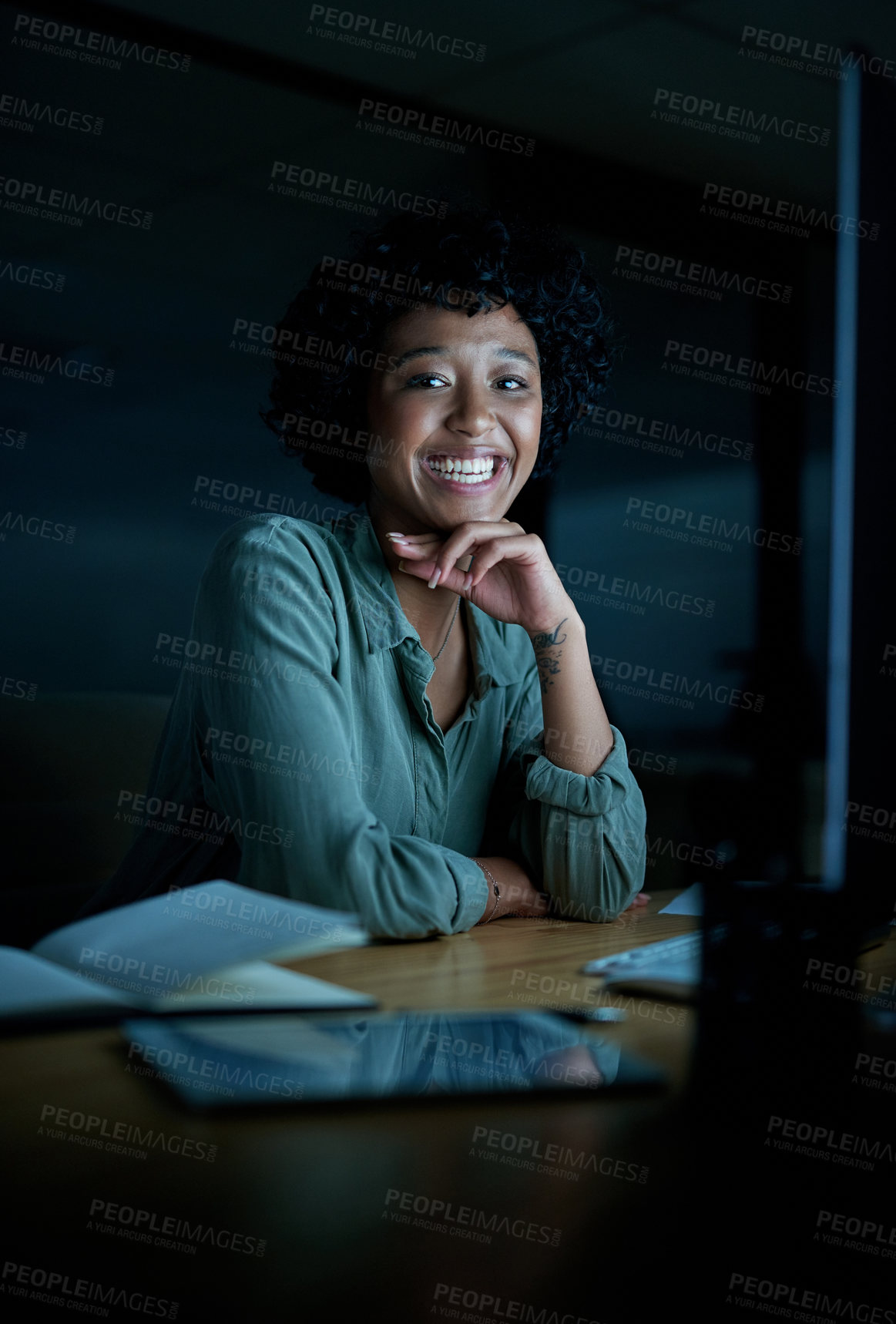 Buy stock photo Portrait of a young businesswoman using a computer during a late night at work