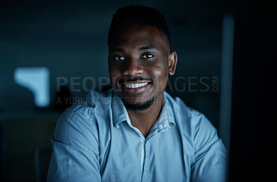 Buy stock photo Portrait of a young businessman using a computer during a late night at work