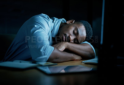Buy stock photo Shot of young businessman sleeping at his desk during a late night in a modern office