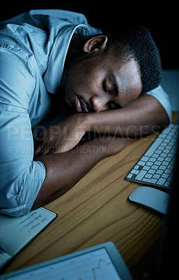 Buy stock photo Shot of young businessman sleeping at his desk during a late night in a modern office