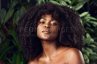 Buy stock photo Shot of a beautiful young woman posing against a leafy background