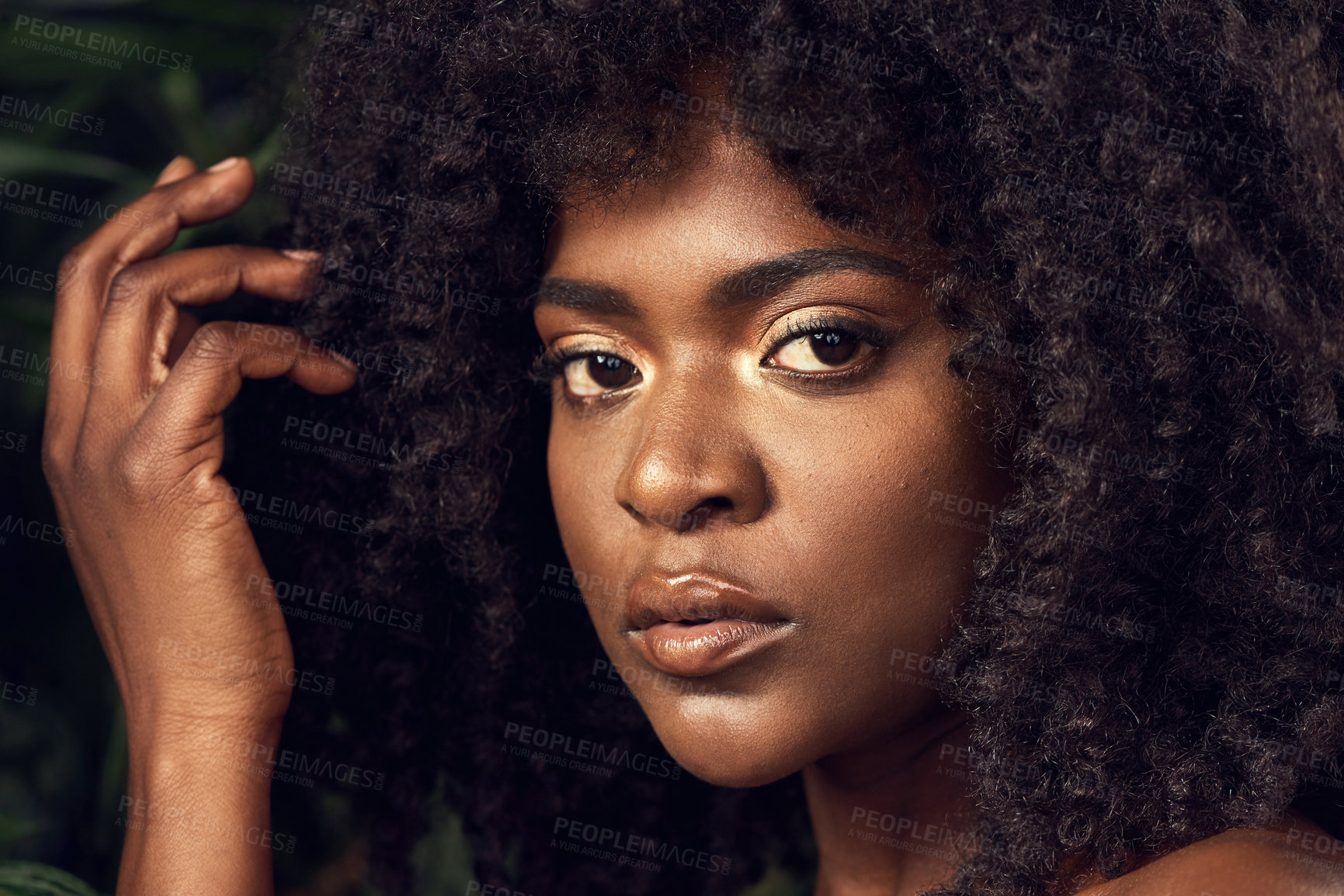 Buy stock photo Shot of a beautiful young woman posing against a leafy background