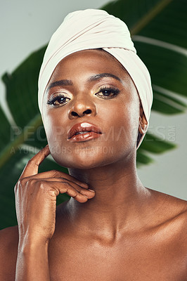 Buy stock photo Studio shot of a beautiful young woman posing against a leafy background