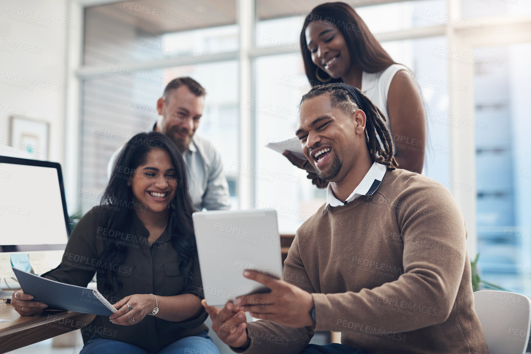 Buy stock photo Cropped shot of a diverse group of businesspeople using technology during a meeting in the office during the day