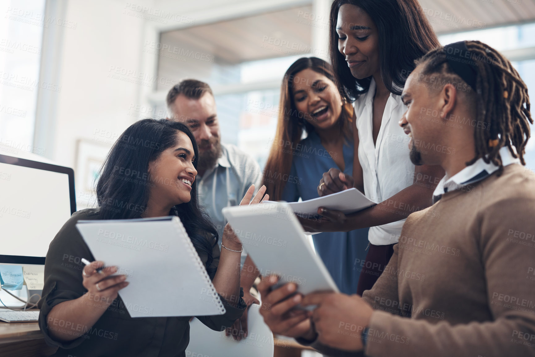 Buy stock photo Cropped shot of a diverse group of businesspeople using technology during a meeting in the office