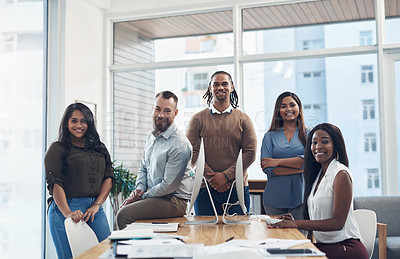 Buy stock photo Cropped portrait of a diverse group of businesspeople surrounding a boardroom desk during a meeting in the office