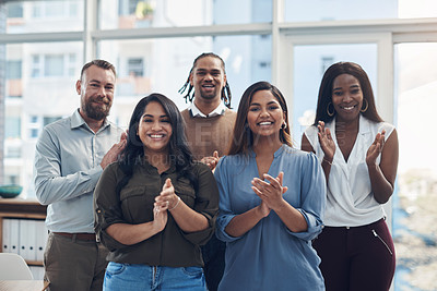 Buy stock photo Cropped portrait of a diverse group of businesspeople standing together and clapping in the office
