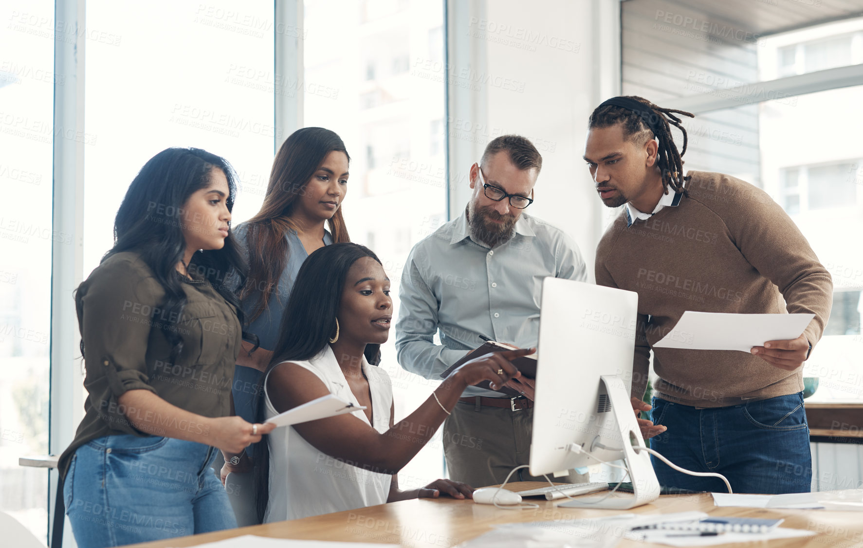 Buy stock photo Cropped shot of a diverse group of businesspeople using technology during a meeting in the office