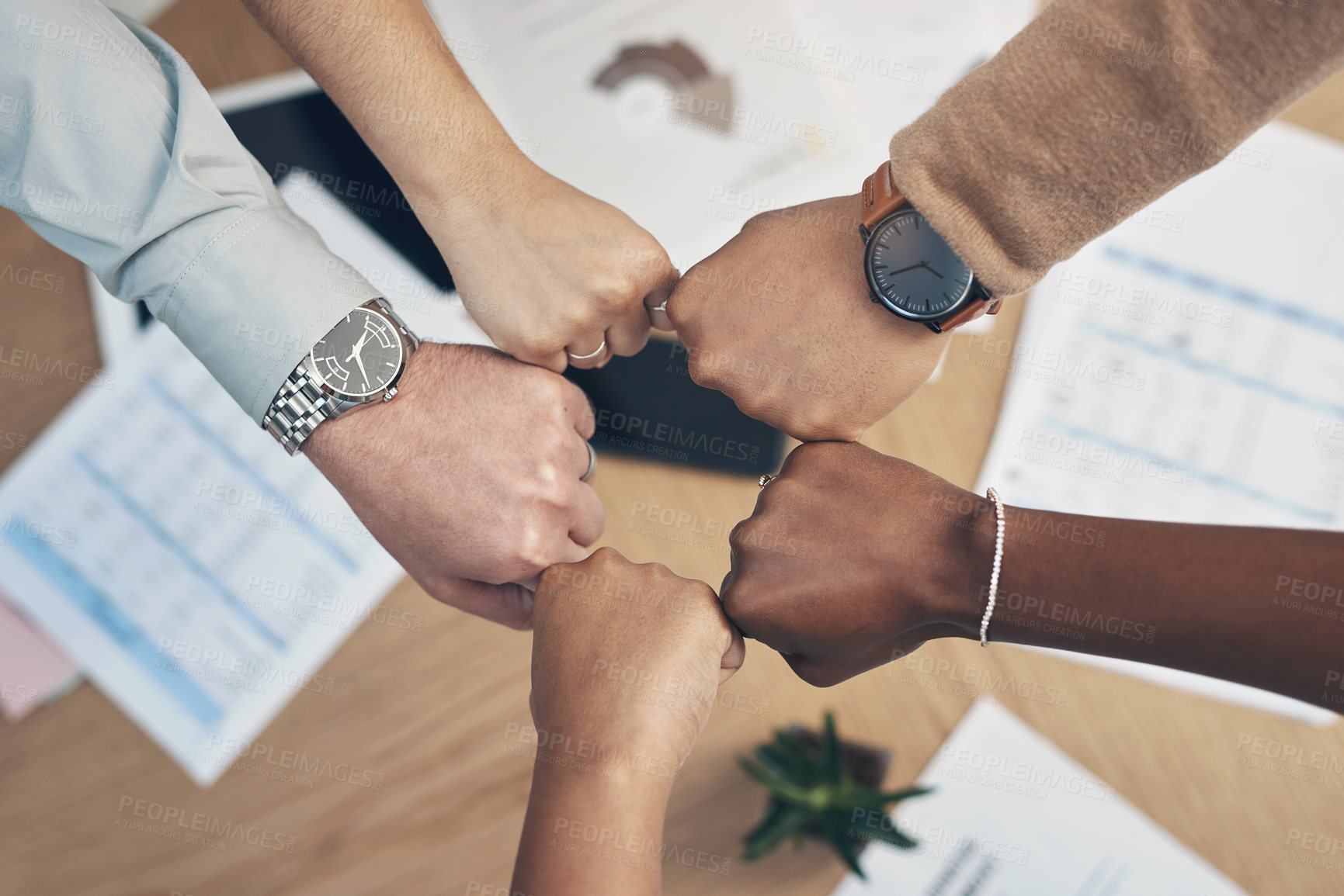 Buy stock photo High angle shot of an unrecognizable group of businesspeople huddled together with their fists in a circle in the office