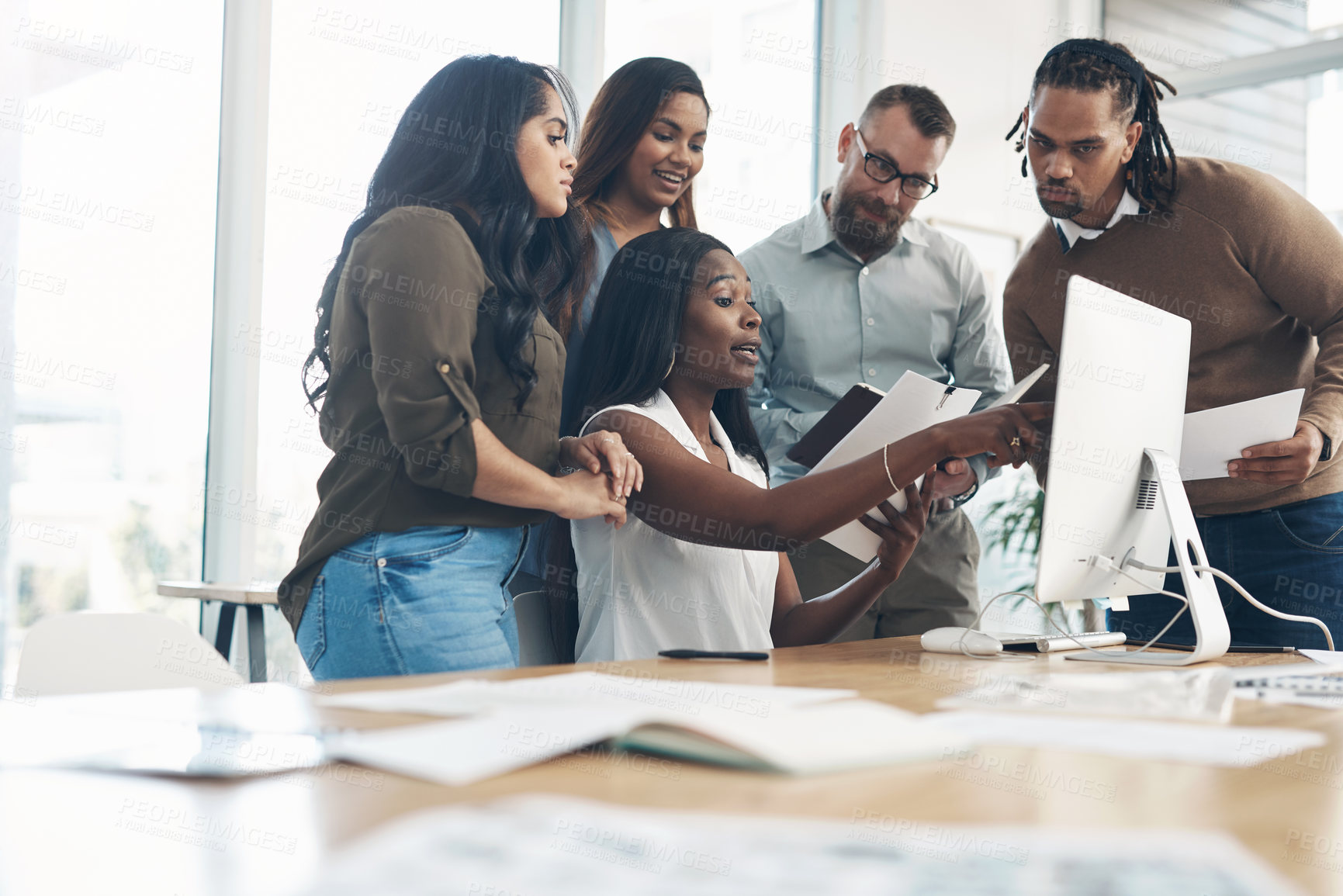 Buy stock photo Cropped shot of a diverse group of businesspeople using technology during a meeting in the office