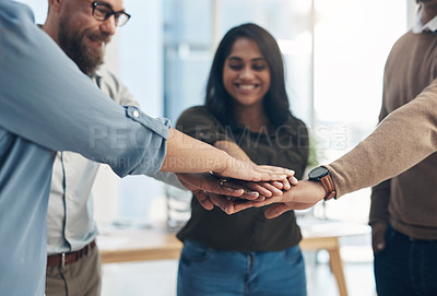 Buy stock photo Cropped shot of a diverse group of businesspeople huddled with their hands piled together in the office