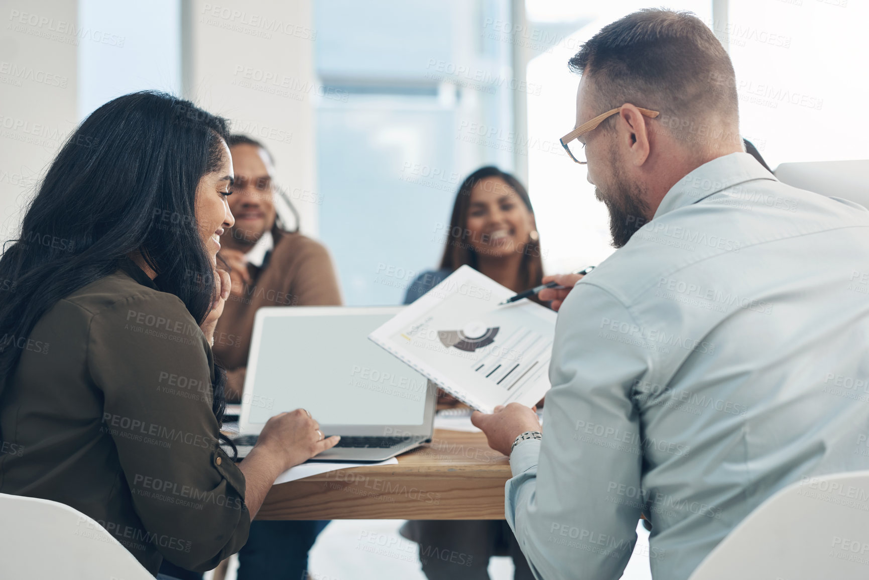 Buy stock photo Cropped shot of a diverse group of businesspeople sitting together during a meeting in the office